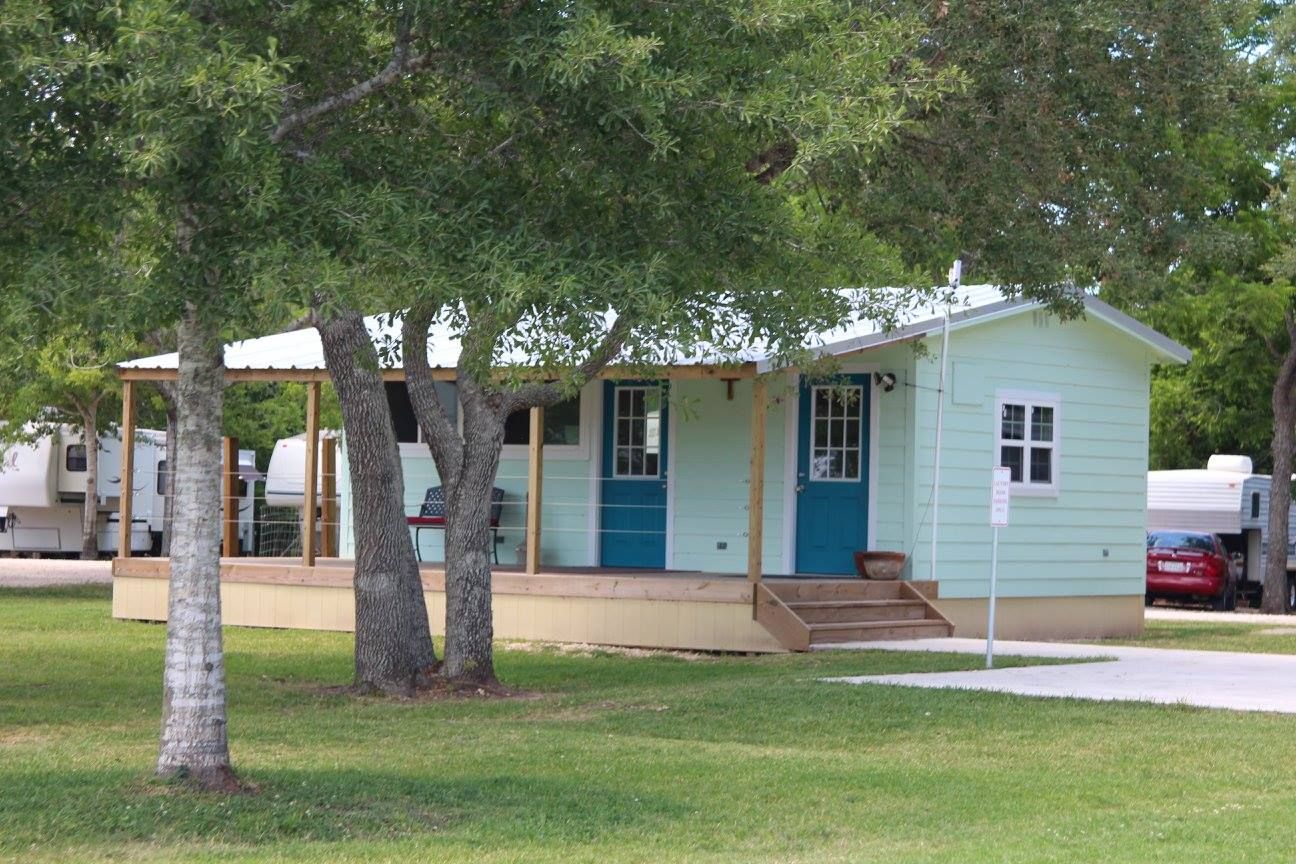 Park amenity building beneath mature shade trees