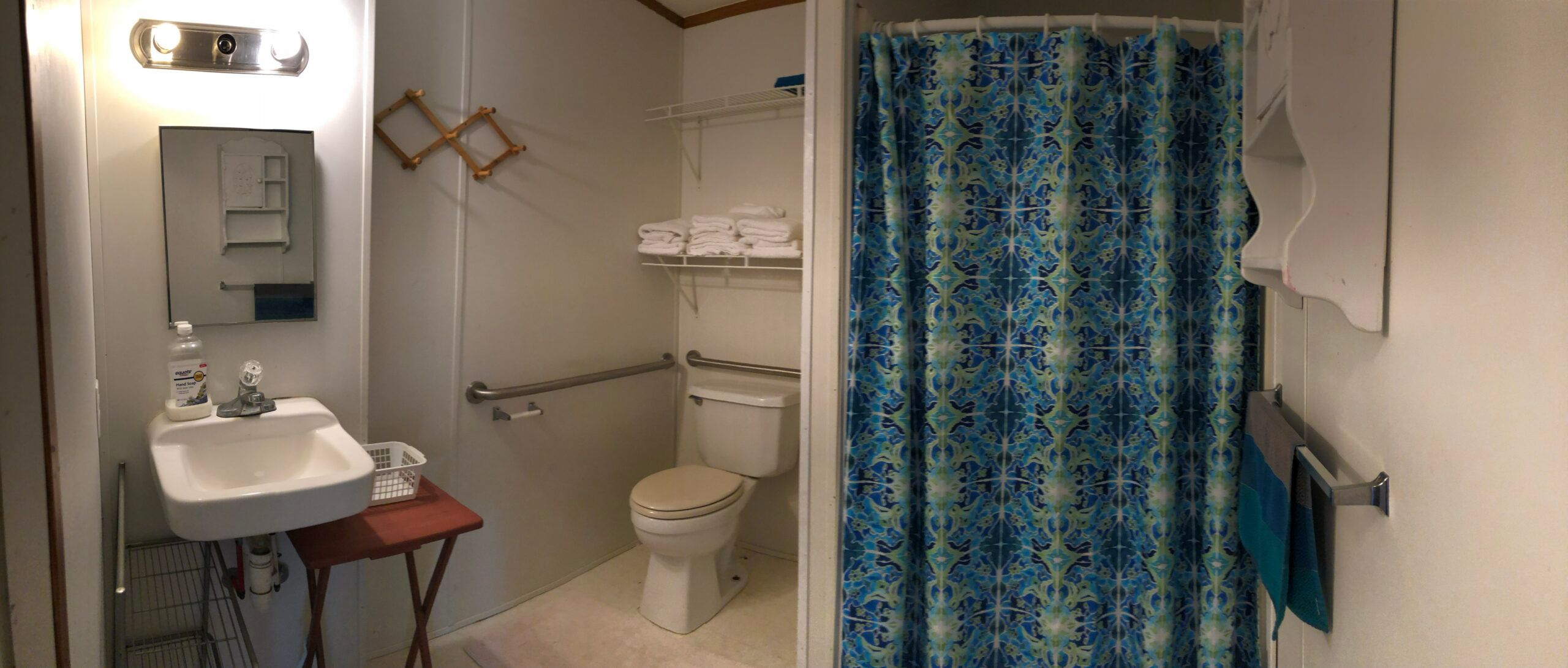 Full bathroom with wall-mounted grab bars inside the park's mini-house